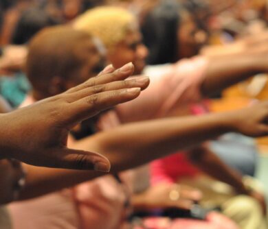 African American hands reach out in prayer during a praise and worship moment African American hands reach out in prayer during a praise and worship moment