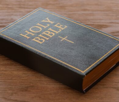 close-up shot of holy bible lying on wooden surface close-up shot of holy bible lying on wooden surface